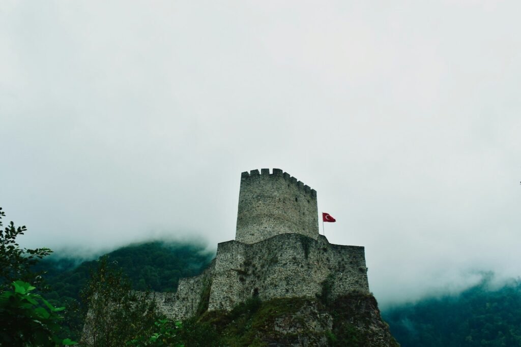 Stone castle on a rocky hill under cloudy sky